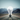 Giant clear lightbulb sitting upright in the middle of a highway with the mountains in the background